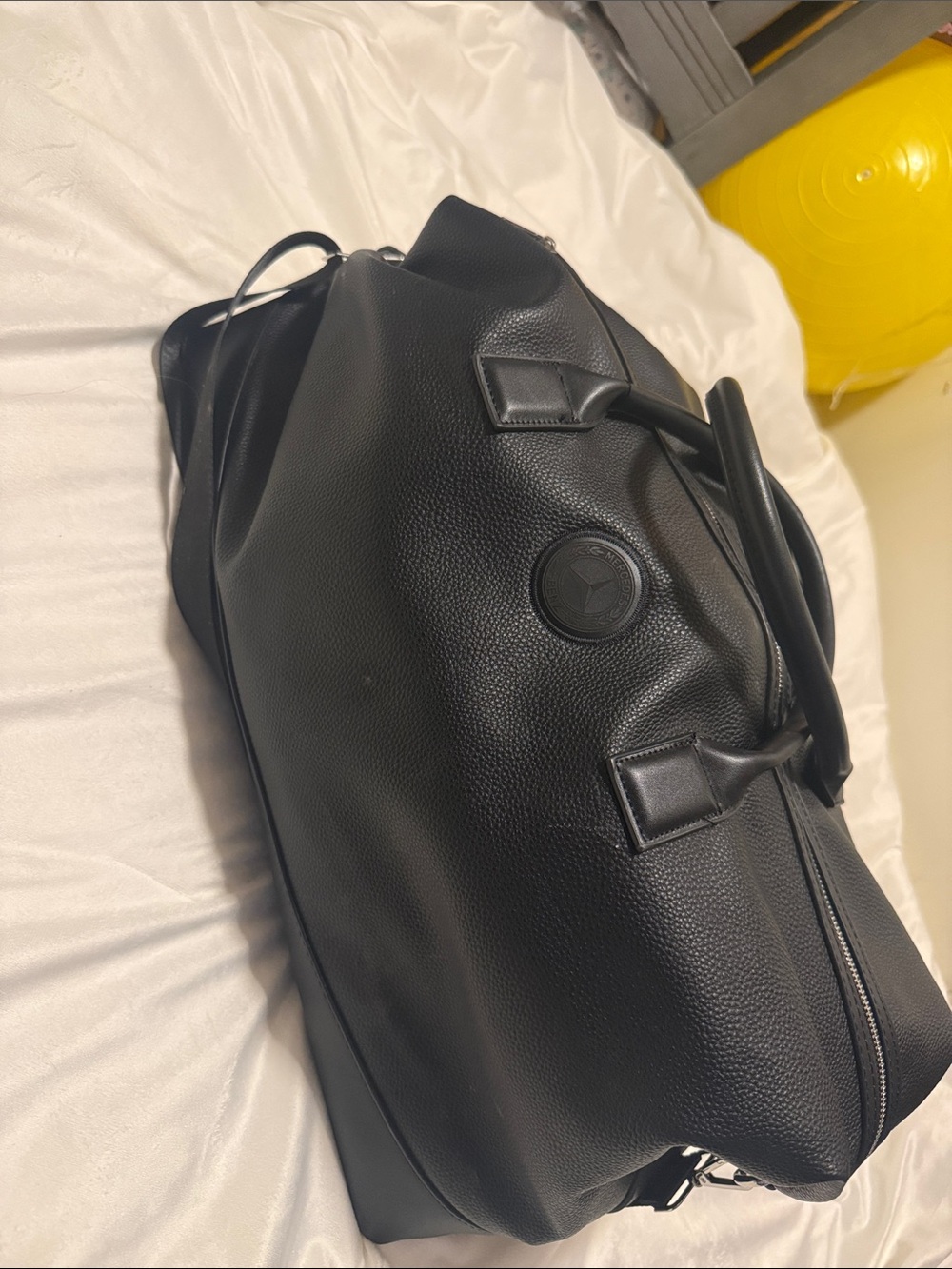 Black Pebbled Leather Duffel Bag with Embossed Round Logo